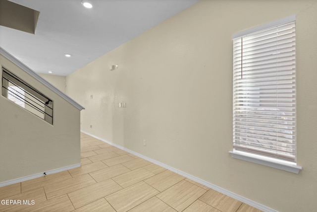 unfurnished room featuring wood finish floors, baseboards, and recessed lighting