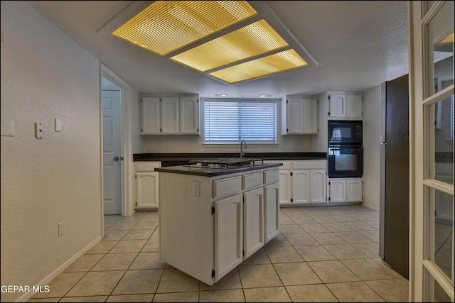 kitchen featuring white cabinetry and black appliances