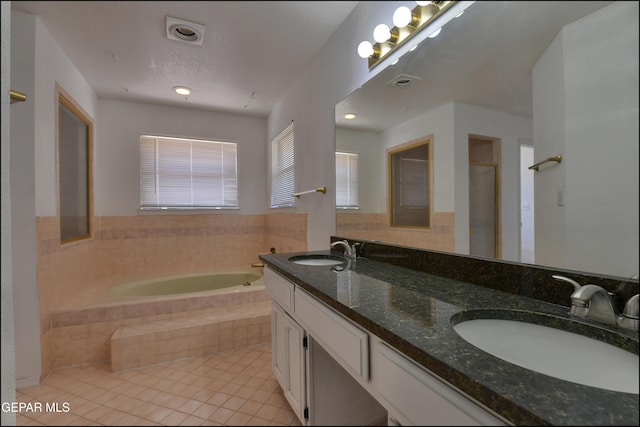 full bathroom with a sink, a bath, double vanity, and tile patterned flooring