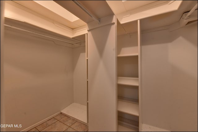 spacious closet featuring light tile patterned floors