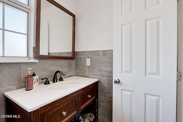 bathroom featuring vanity and tile walls