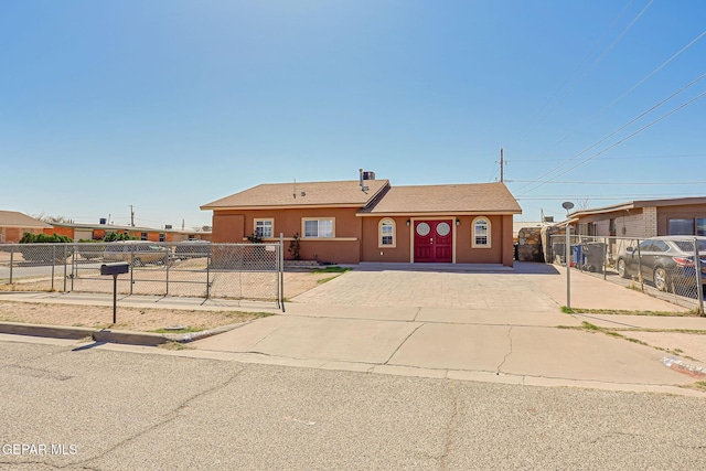 ranch-style house with fence, driveway, and stucco siding