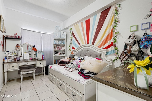 bedroom with light tile patterned floors and a textured ceiling