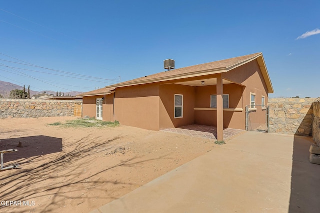 back of house featuring a patio area, stucco siding, and fence