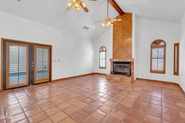 unfurnished living room featuring tile patterned flooring, visible vents, baseboards, a tiled fireplace, and beamed ceiling