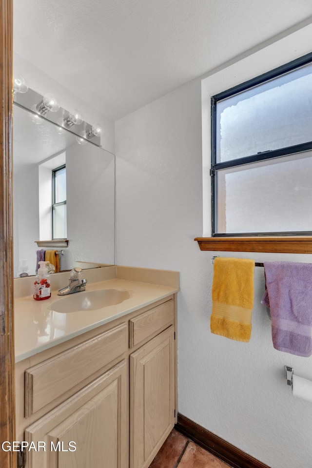 bathroom featuring vanity and baseboards