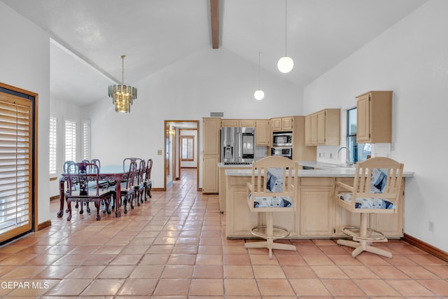 kitchen with beam ceiling, high vaulted ceiling, light brown cabinets, appliances with stainless steel finishes, and a peninsula