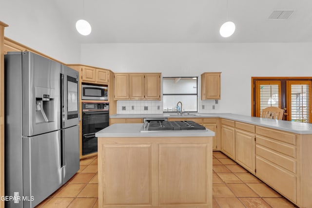 kitchen with visible vents, a sink, light brown cabinetry, appliances with stainless steel finishes, and tasteful backsplash