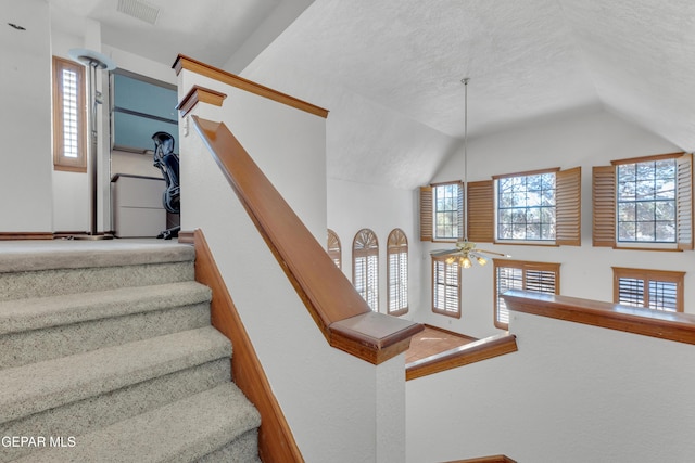 stairway featuring visible vents, high vaulted ceiling, and ceiling fan