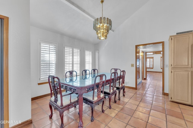 dining area with plenty of natural light, baseboards, an inviting chandelier, and vaulted ceiling