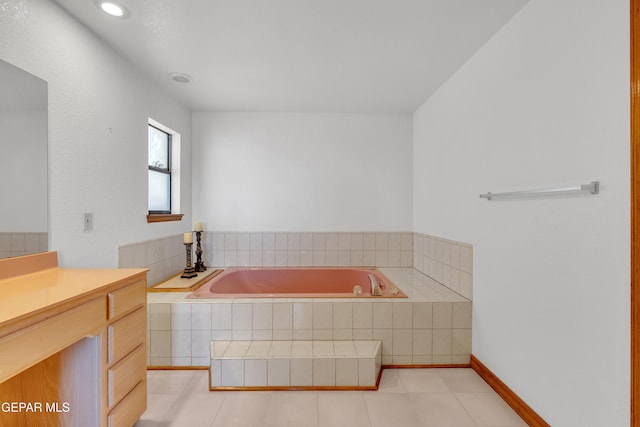 full bath with a bath, vanity, and tile patterned flooring