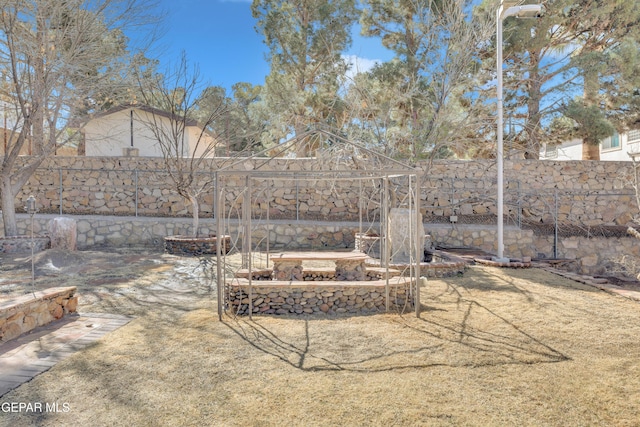 view of yard featuring a vegetable garden and a fenced backyard