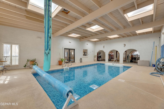 view of pool featuring a covered pool and a skylight