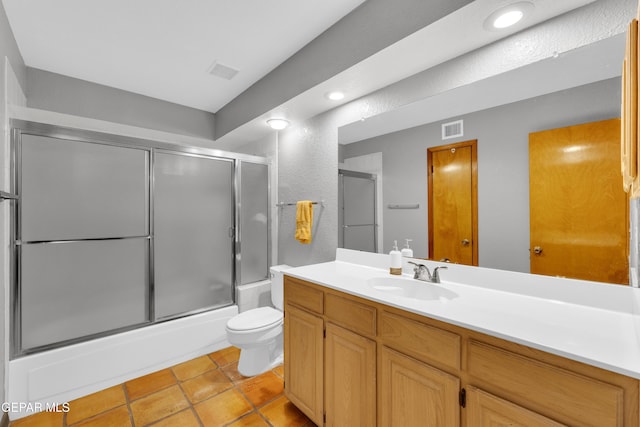 bathroom featuring visible vents, toilet, tile patterned flooring, bath / shower combo with glass door, and vanity