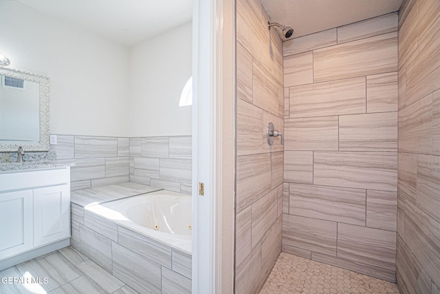 full bathroom with a tile shower, visible vents, vanity, and a whirlpool tub