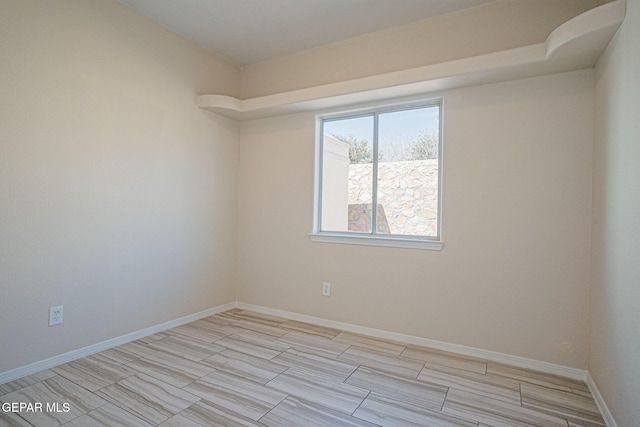 empty room with baseboards