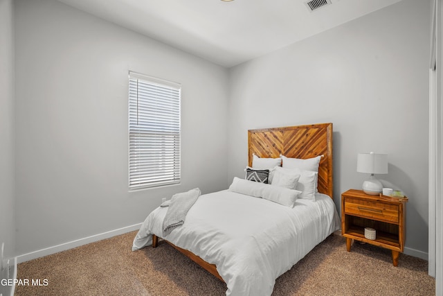 carpeted bedroom with visible vents and baseboards