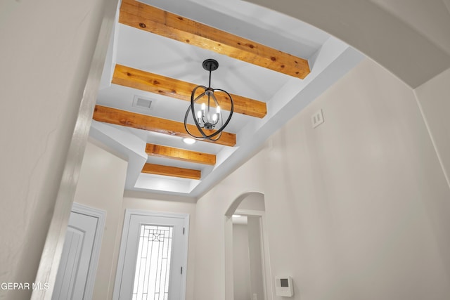 interior details with beam ceiling and an inviting chandelier