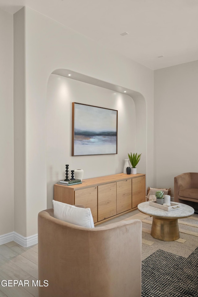 living area with baseboards and light wood-style floors