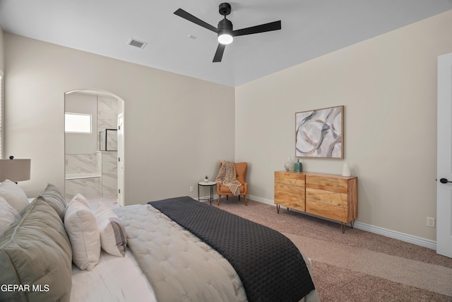 carpeted bedroom featuring visible vents, ceiling fan, baseboards, ensuite bathroom, and arched walkways