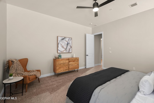 bedroom featuring visible vents, baseboards, carpet, and a ceiling fan