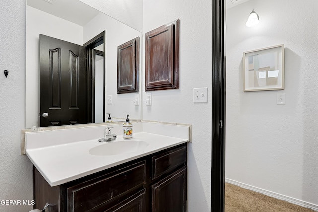 bathroom with vanity and baseboards