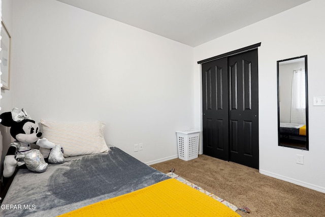 bedroom featuring a closet, carpet flooring, and baseboards