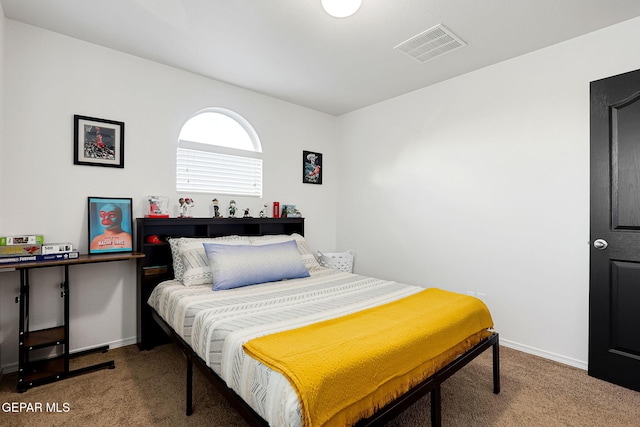 bedroom featuring visible vents, baseboards, and carpet