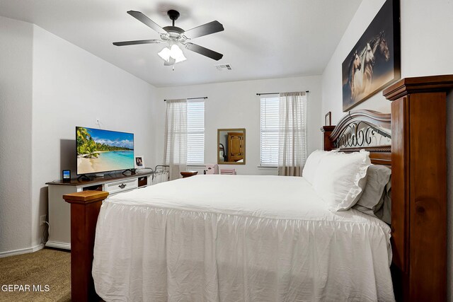 bedroom featuring visible vents, carpet flooring, a ceiling fan, and baseboards