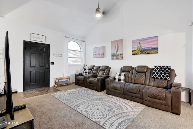 carpeted living area with high vaulted ceiling