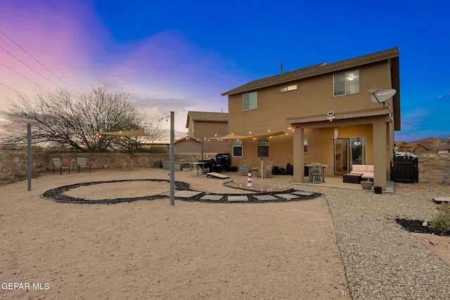 rear view of property with a patio area, stucco siding, and fence