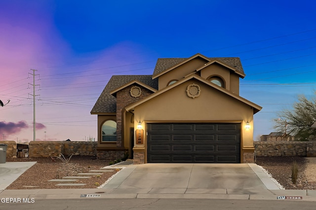 traditional-style house with driveway, a shingled roof, stucco siding, a garage, and stone siding