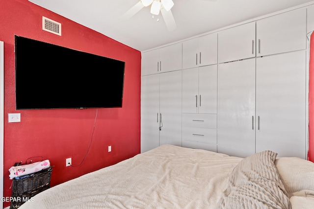 bedroom with a closet, visible vents, and a ceiling fan