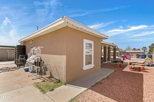 view of side of home featuring stucco siding