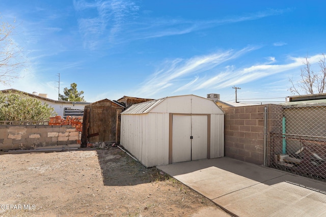 view of shed with fence