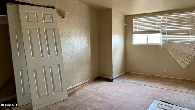 empty room featuring baseboards