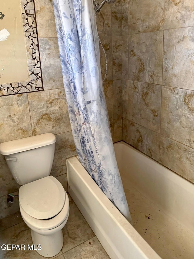 bathroom with tile patterned floors, toilet, and shower / tub combo with curtain