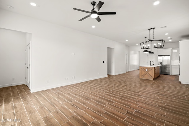 unfurnished living room featuring a sink, recessed lighting, a ceiling fan, and wood tiled floor