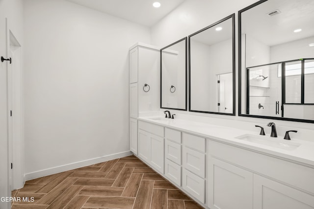 full bathroom with a sink, visible vents, baseboards, and a stall shower