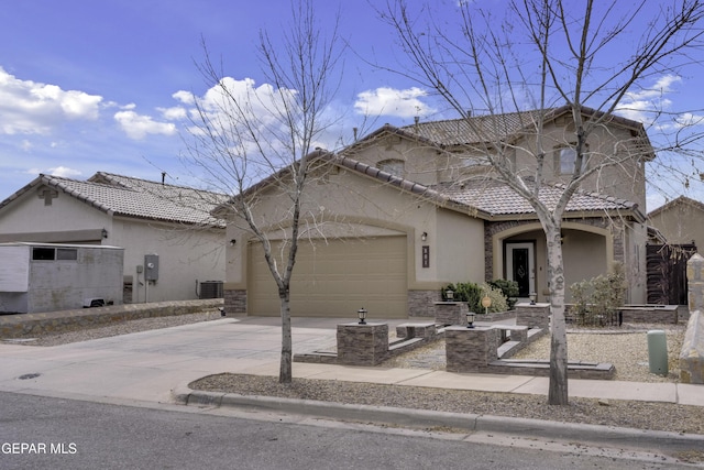 view of front of house featuring stucco siding, driveway, a tile roof, a garage, and central AC unit