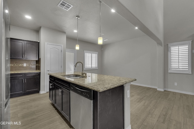 kitchen featuring a sink, visible vents, stainless steel dishwasher, and light wood-style flooring