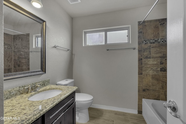 bathroom with toilet, wood finished floors, tub / shower combination, baseboards, and vanity