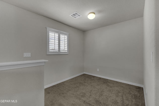 unfurnished room with visible vents, baseboards, and carpet floors