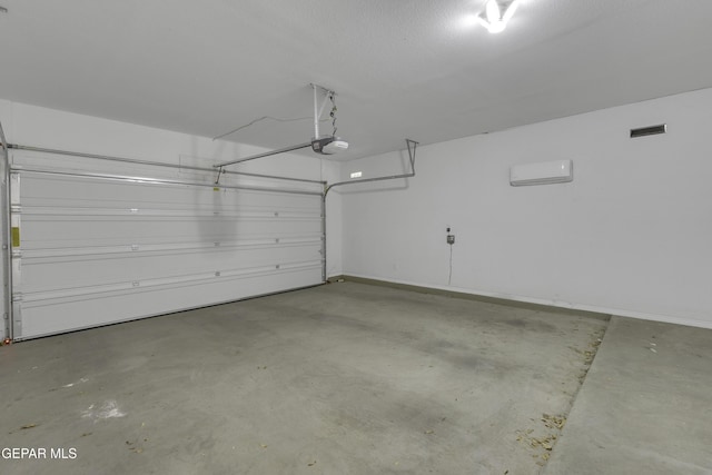 garage featuring visible vents and a garage door opener