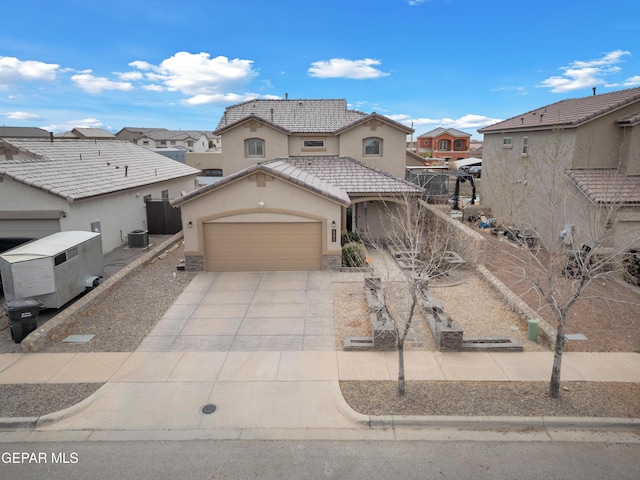 view of front of home with cooling unit, stucco siding, concrete driveway, a garage, and a tiled roof