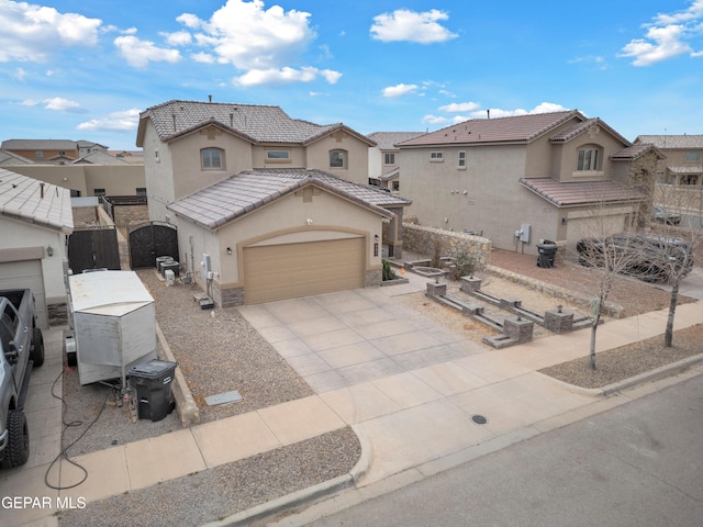 view of front of property with a tiled roof, stucco siding, an attached garage, and driveway