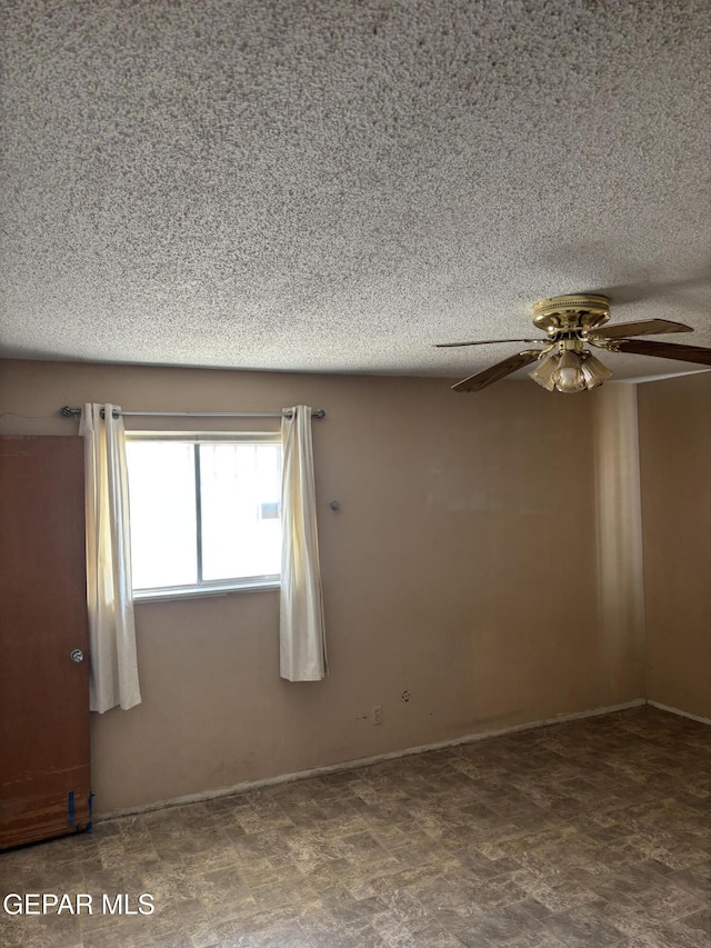 unfurnished room with a textured ceiling and ceiling fan