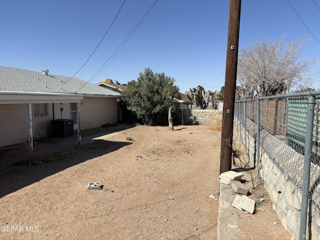 view of yard featuring a patio, central AC unit, and a fenced backyard