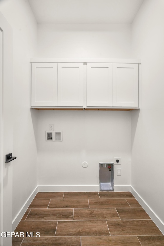 clothes washing area with washer hookup, cabinet space, hookup for a gas dryer, and wood finish floors