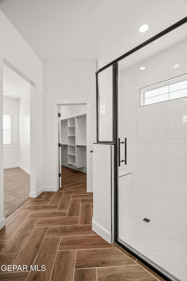 bathroom with a shower stall, recessed lighting, and baseboards